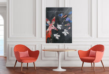 Load image into Gallery viewer, Two red chairs and a small table in a room with a colorful abstract painting on the wall.