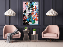 Load image into Gallery viewer, A colorful abstract painting on canvas is displayed on a dark charcoal paneled wall in a modern living room setting, flanked by two pink armchairs and two white pendant lights.